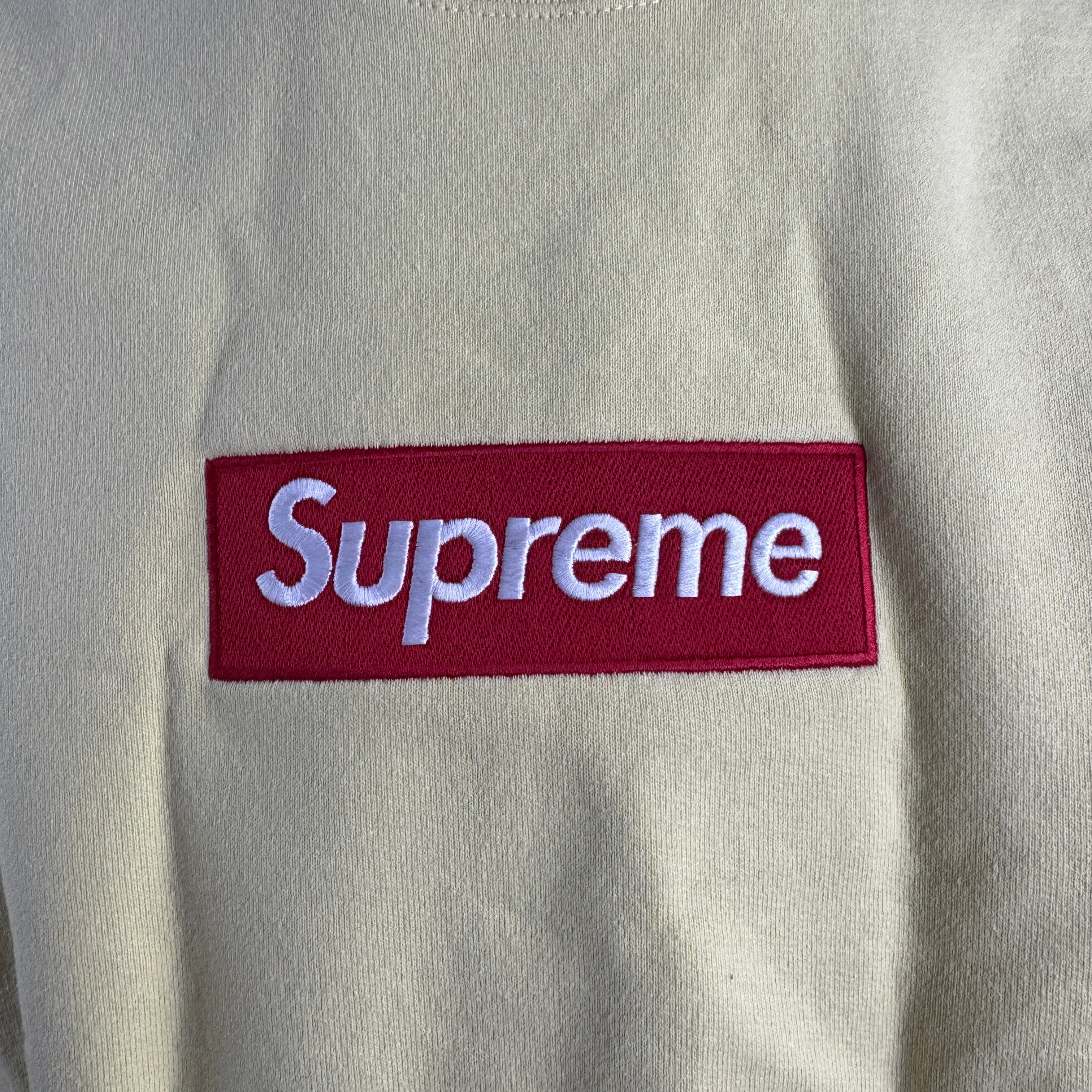 The Supreme Box Logo in pale yellow refers to a signature Supreme piece featuring the iconic box logo graphic set against a