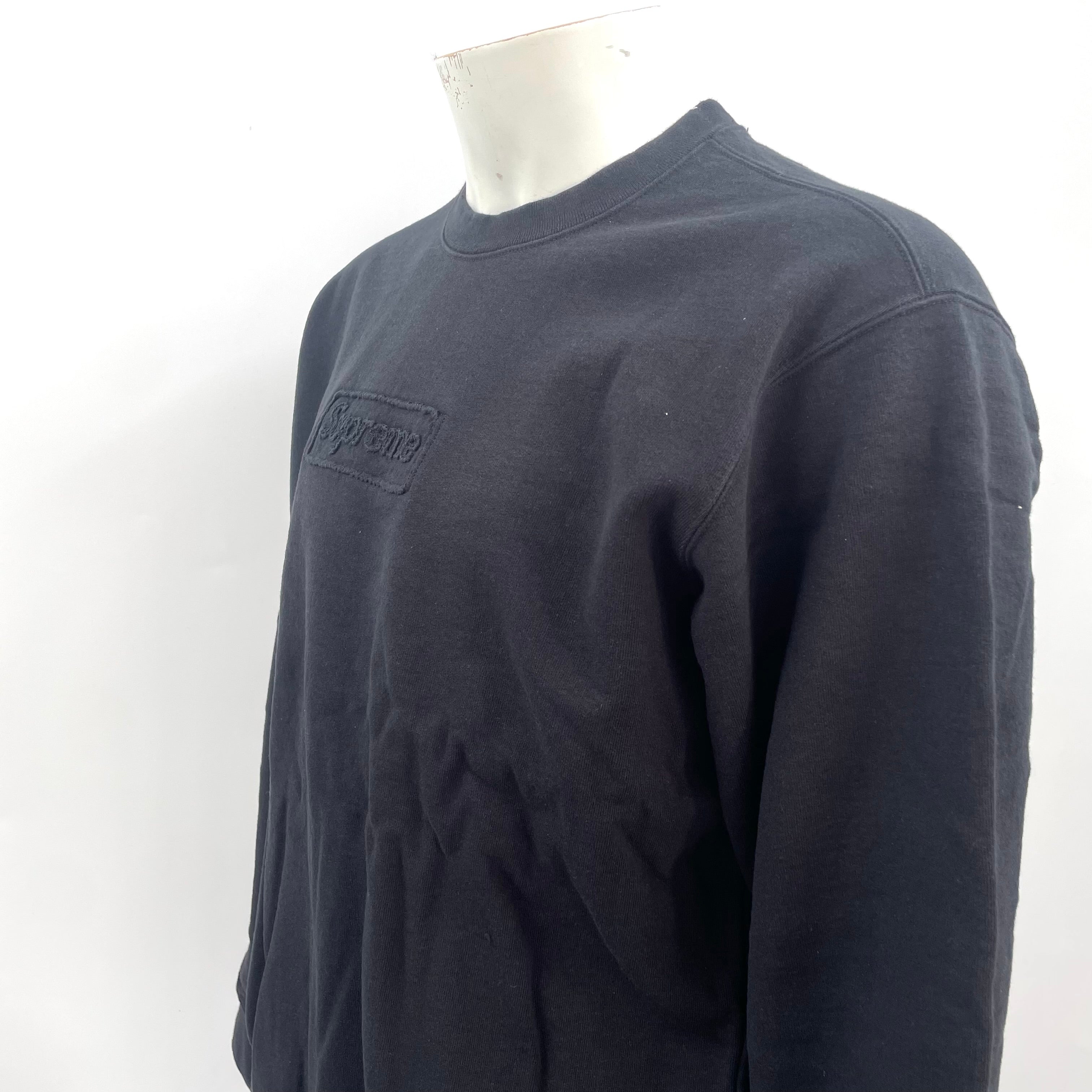 Supreme Cutout Logo Crewneck Sweatshirt in black, featuring a subtle tonal Supreme logo detail on the chest. A clean and