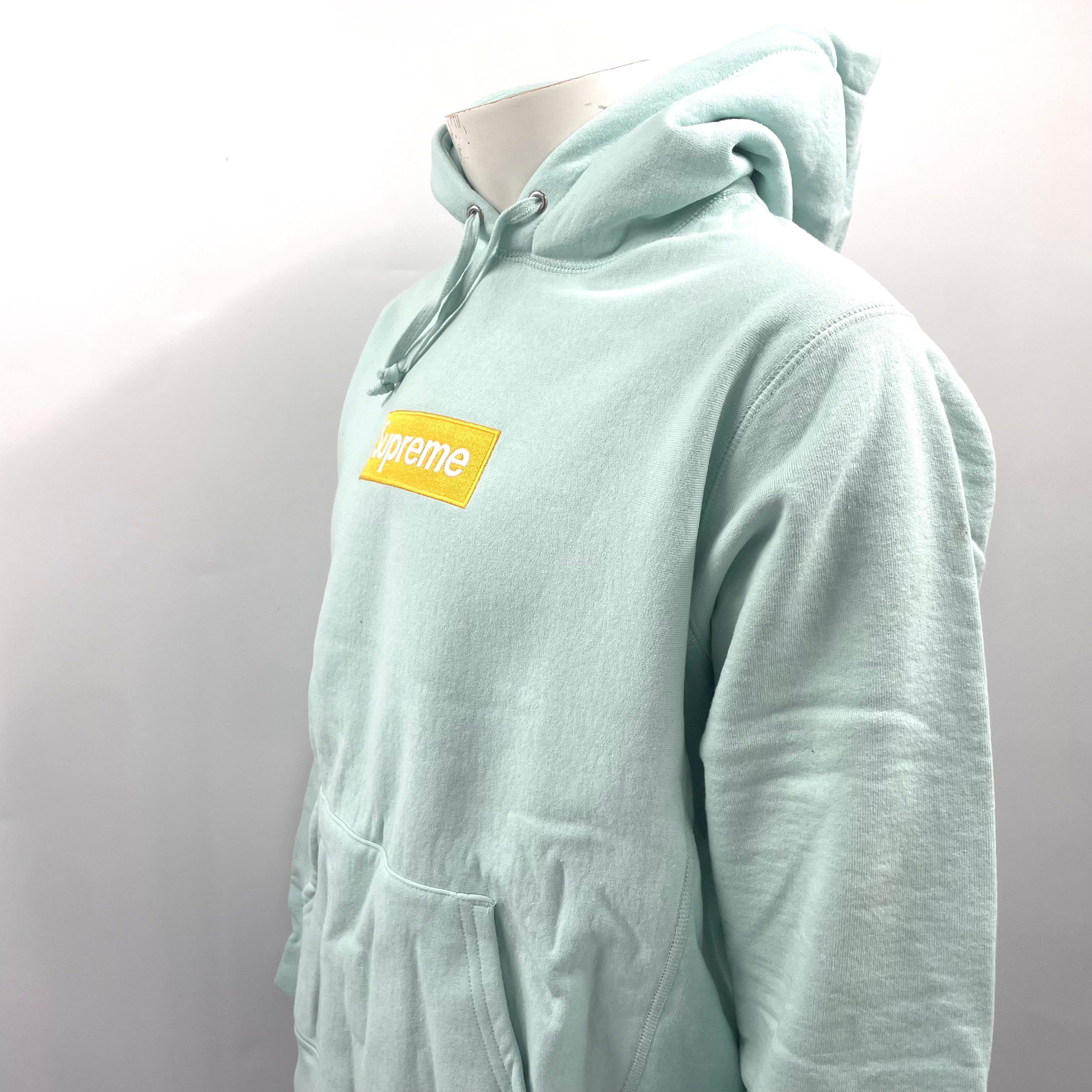 The Supreme Gold Box Logo Hoodie Ice Blue is a heavyweight cotton hoodie featuring the iconic Supreme Box Logo embroidered