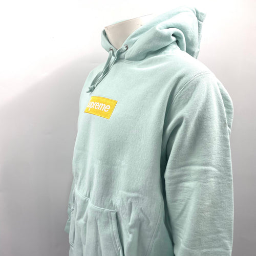 The Supreme Gold Box Logo Hoodie Ice Blue is a heavyweight cotton hoodie featuring the iconic Supreme Box Logo embroidered