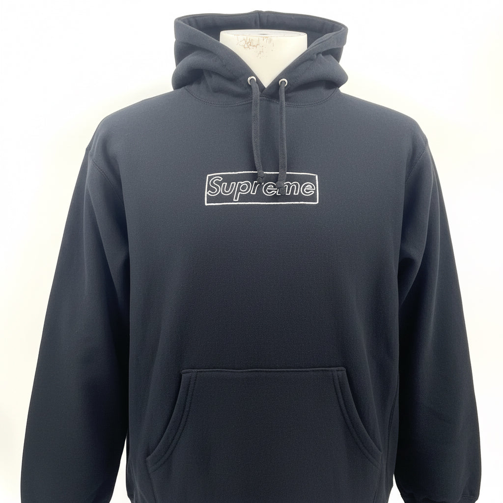 The Supreme KAWS Chalk Hooded Sweatshirt Black is a heavyweight cotton hoodie featuring KAWS’ signature chalk-style Box Logo