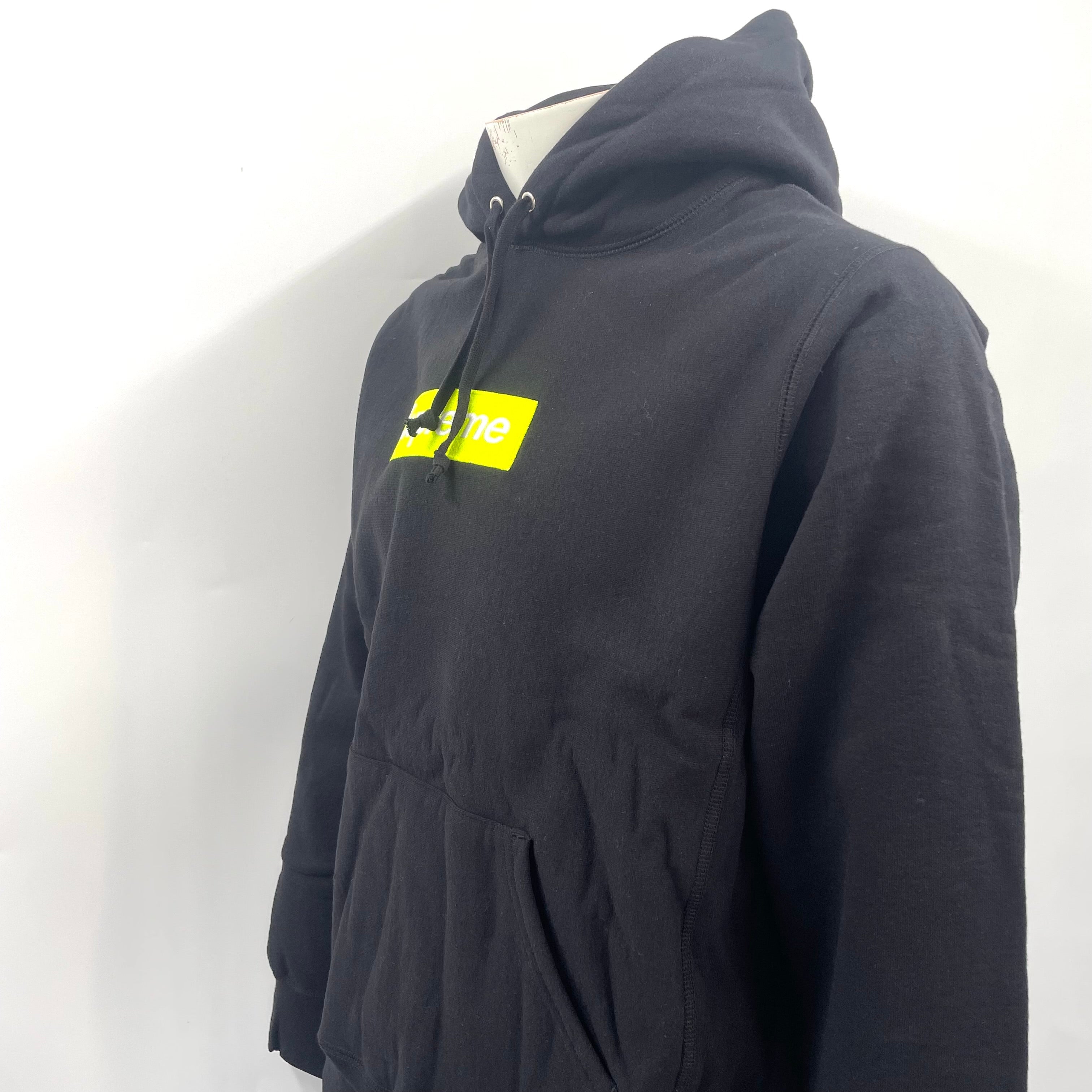 The Supreme Neon Box Logo Hoodie Black is a premium heavyweight cotton hoodie featuring the iconic box logo with a