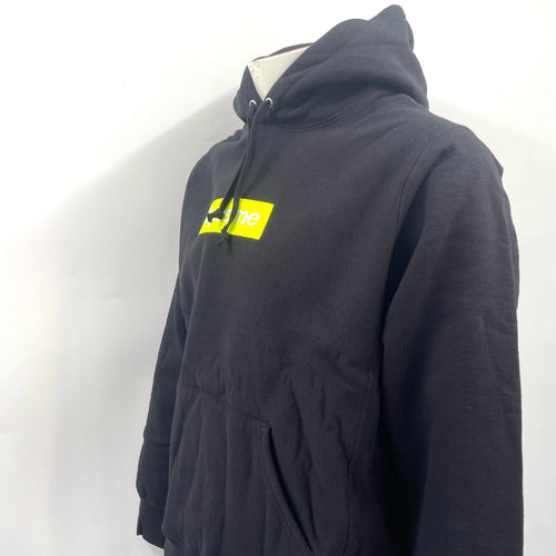 The Supreme Neon Box Logo Hoodie Black is a premium heavyweight cotton hoodie featuring the iconic box logo with a