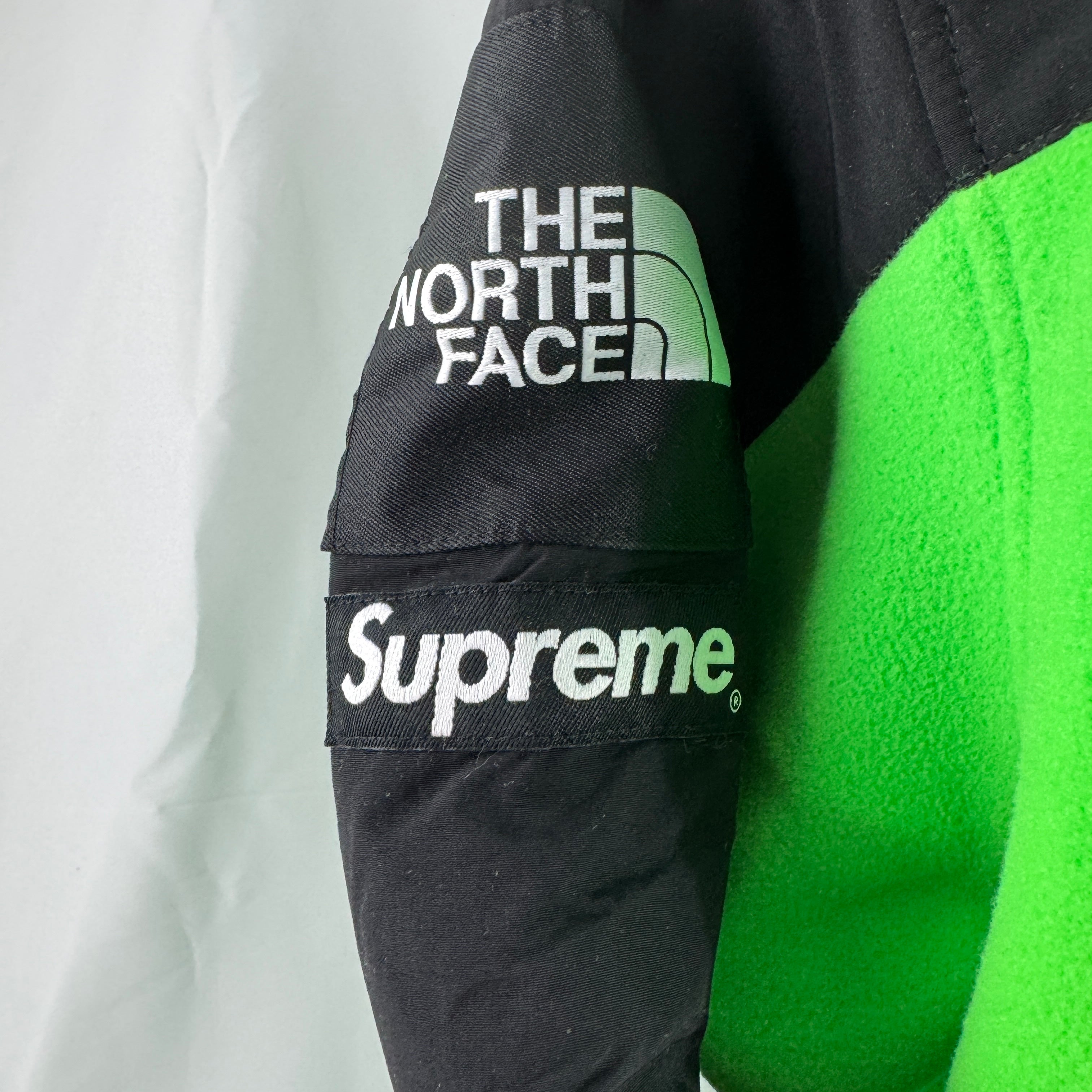 The Supreme x The North Face RTG Fleece Jacket is a collaborative outerwear piece made from warm, soft fleece with durable