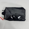 The Supreme Toiletry Bag Black With See-Through Front is a compact travel pouch made from durable material with a clear