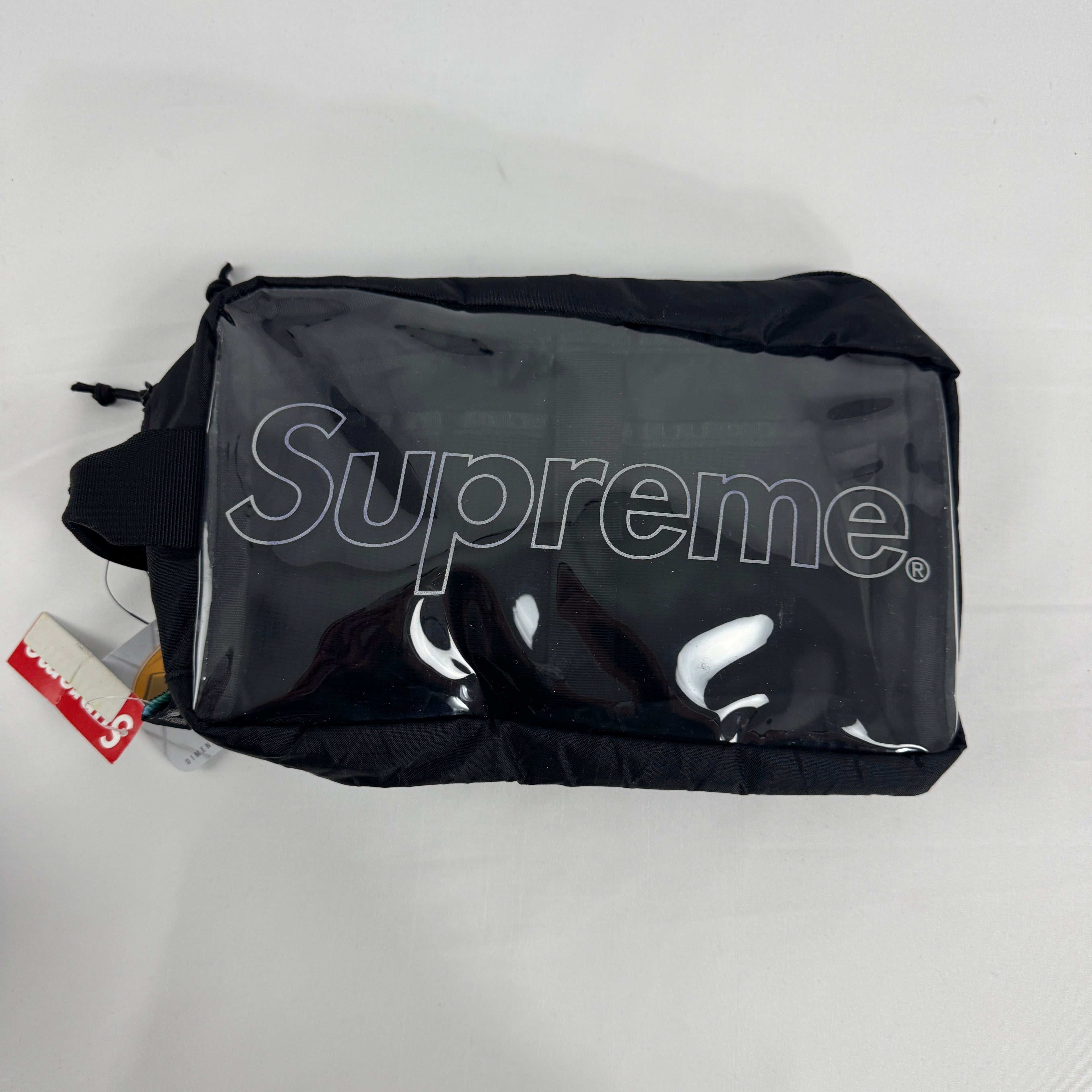 The Supreme Toiletry Bag Black With See-Through Front is a compact travel pouch made from durable material with a clear