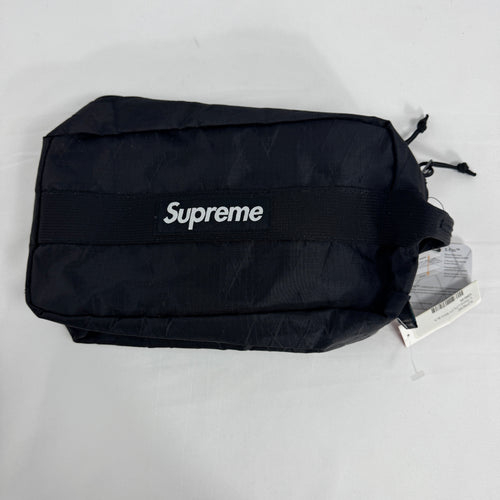 The Supreme Toiletry Bag Black With See-Through Front is a compact travel pouch made from durable material with a clear