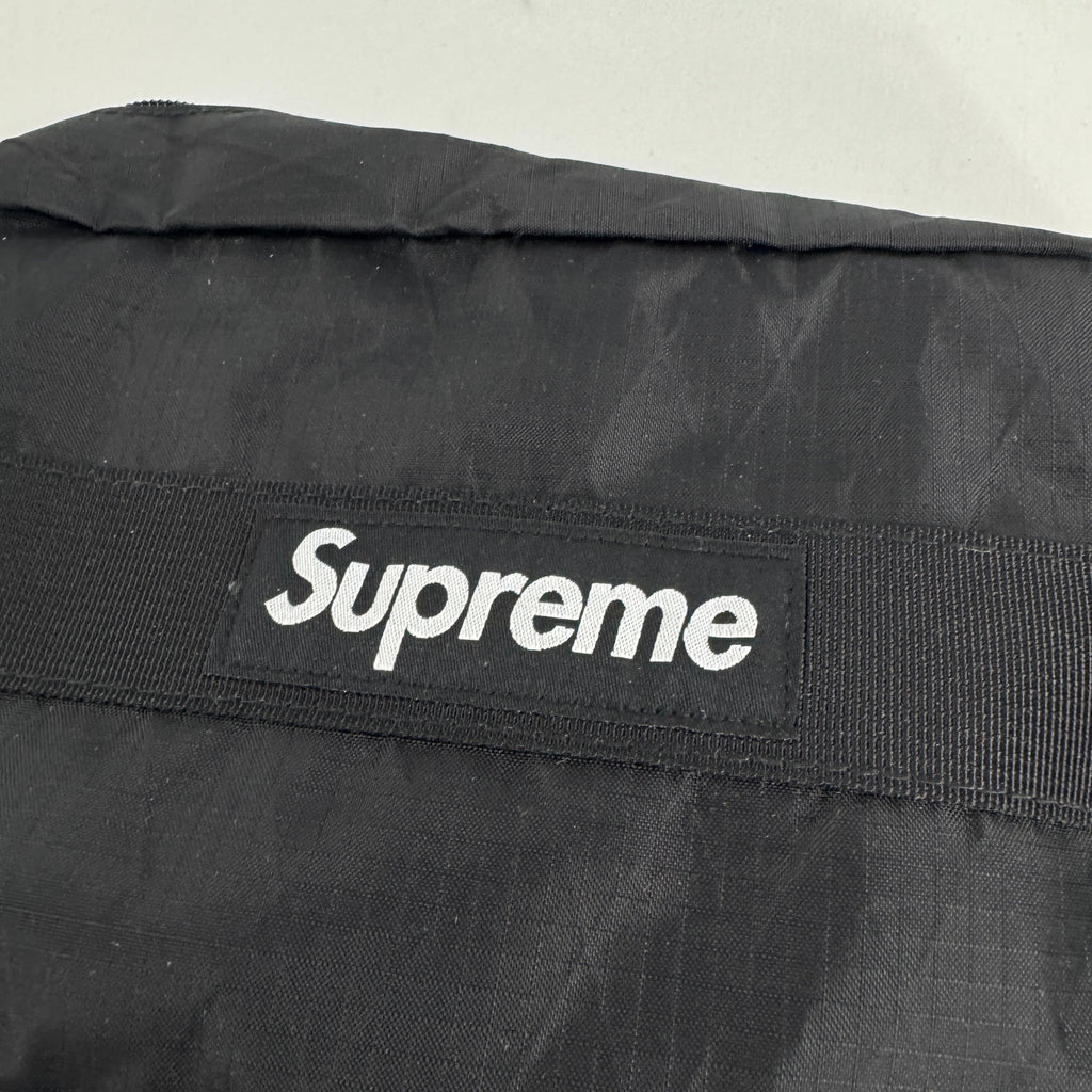 The Supreme Toiletry Bag Black With See-Through Front is a compact travel pouch made from durable material with a clear
