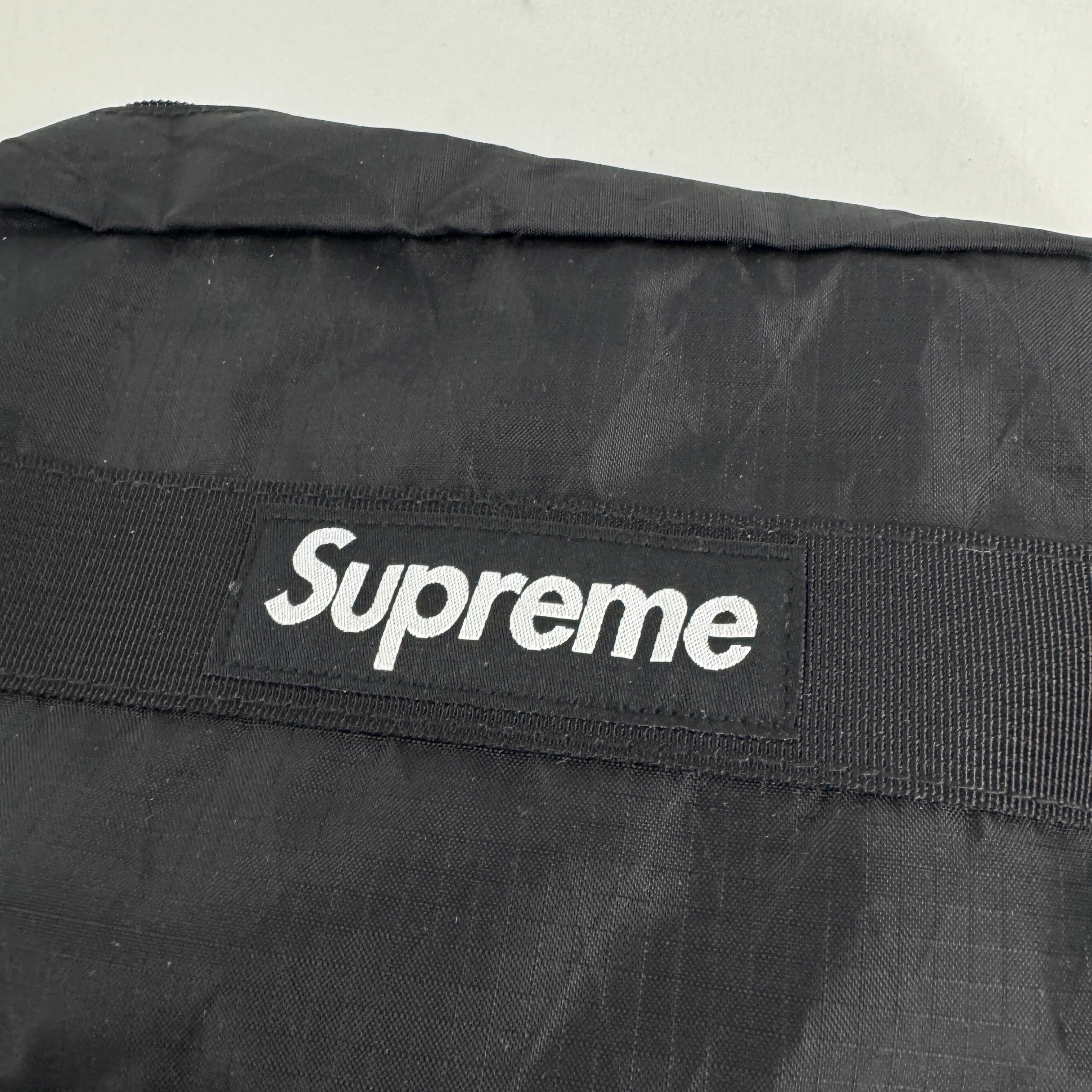 The Supreme Toiletry Bag Black With See-Through Front is a compact travel pouch made from durable material with a clear