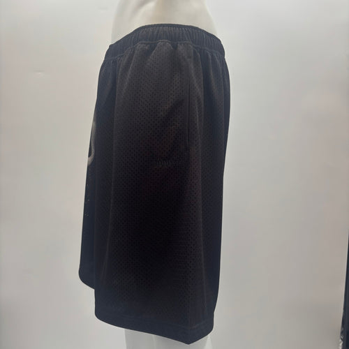 Side view of a mannequin wearing SUPREME X Ghostface shorts with an elastic waistband and mesh fabric, on a light background.