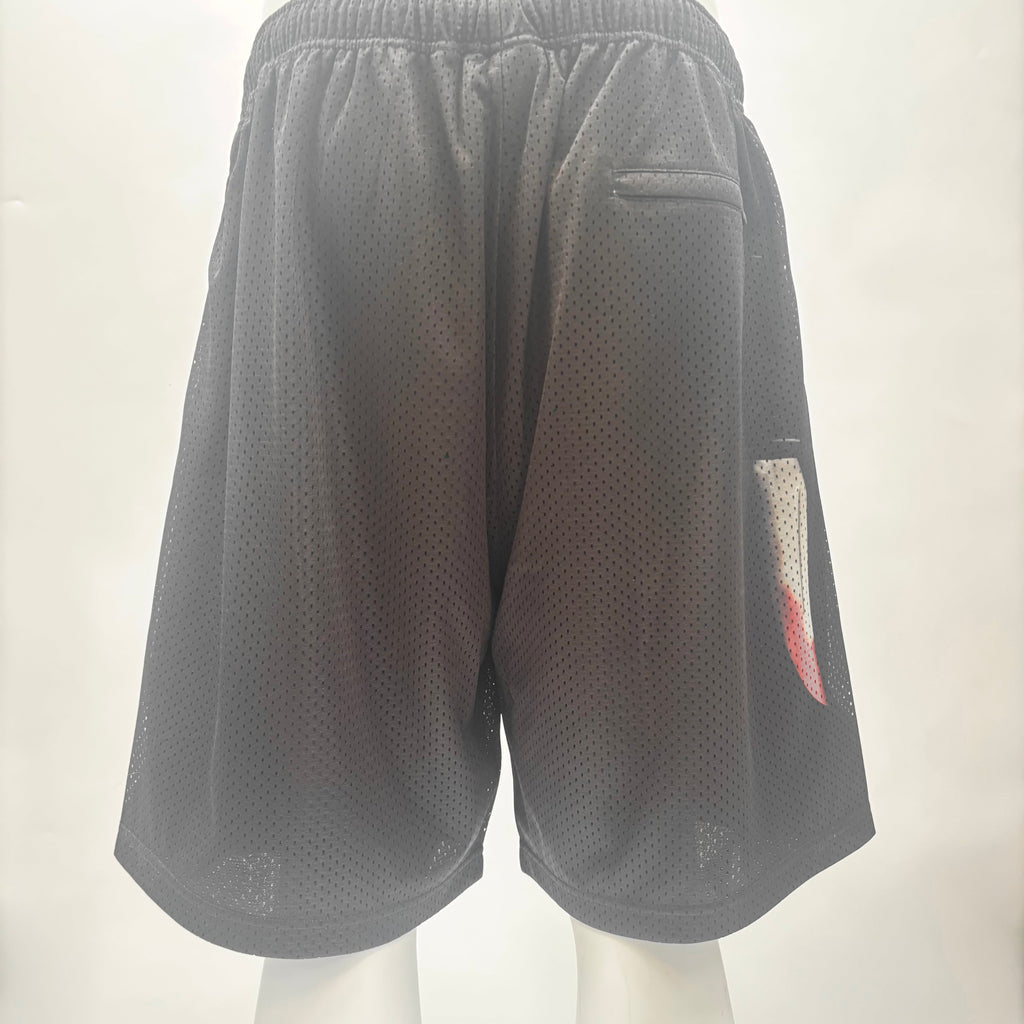 Back view of black SUPREME X Ghostface mesh shorts with elastic waistband, small back pocket, and colourful graphic on right leg.