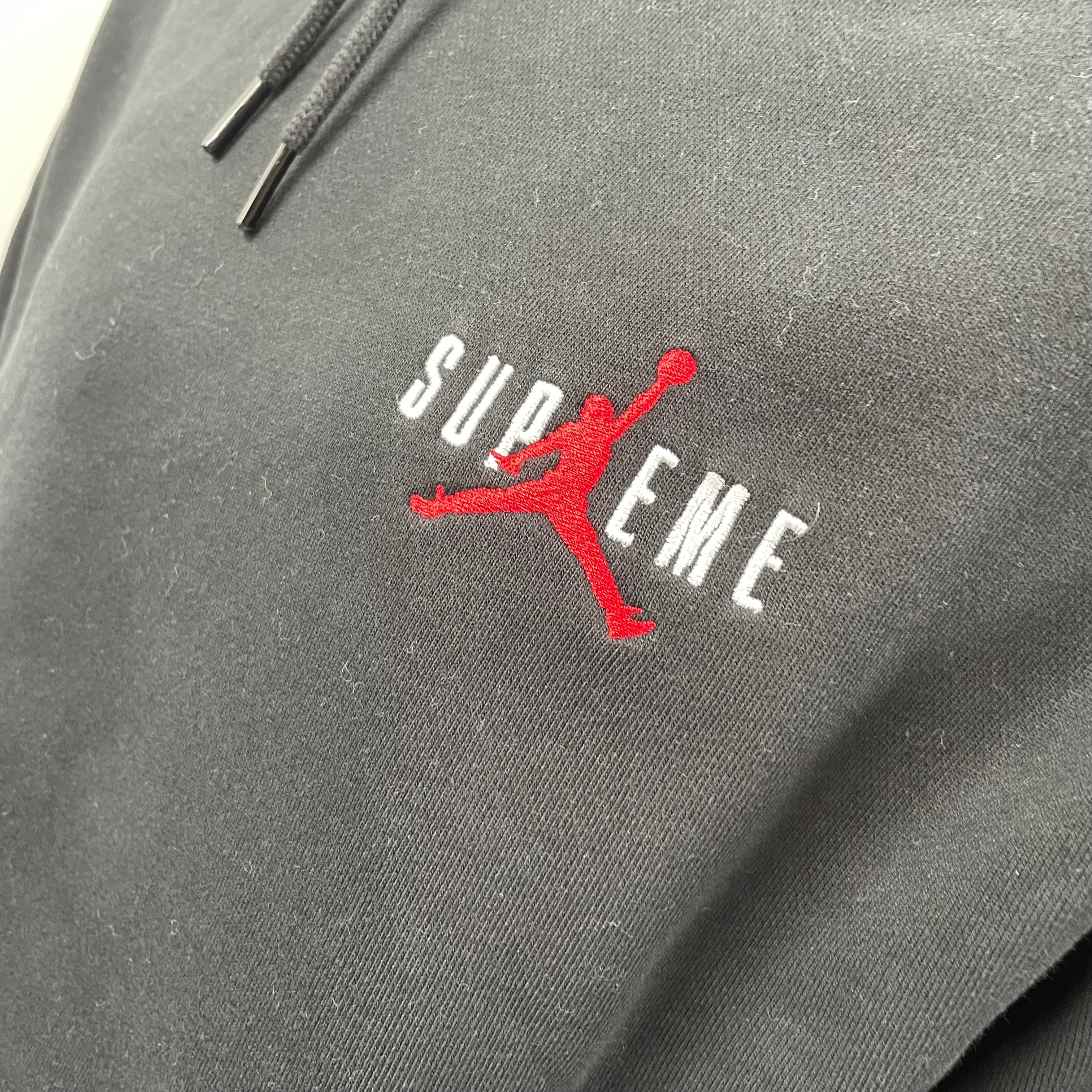 A standout Supreme x Jordan black hoodie with embroidered front branding, bold rear Jumpman logo, drawstring hood and