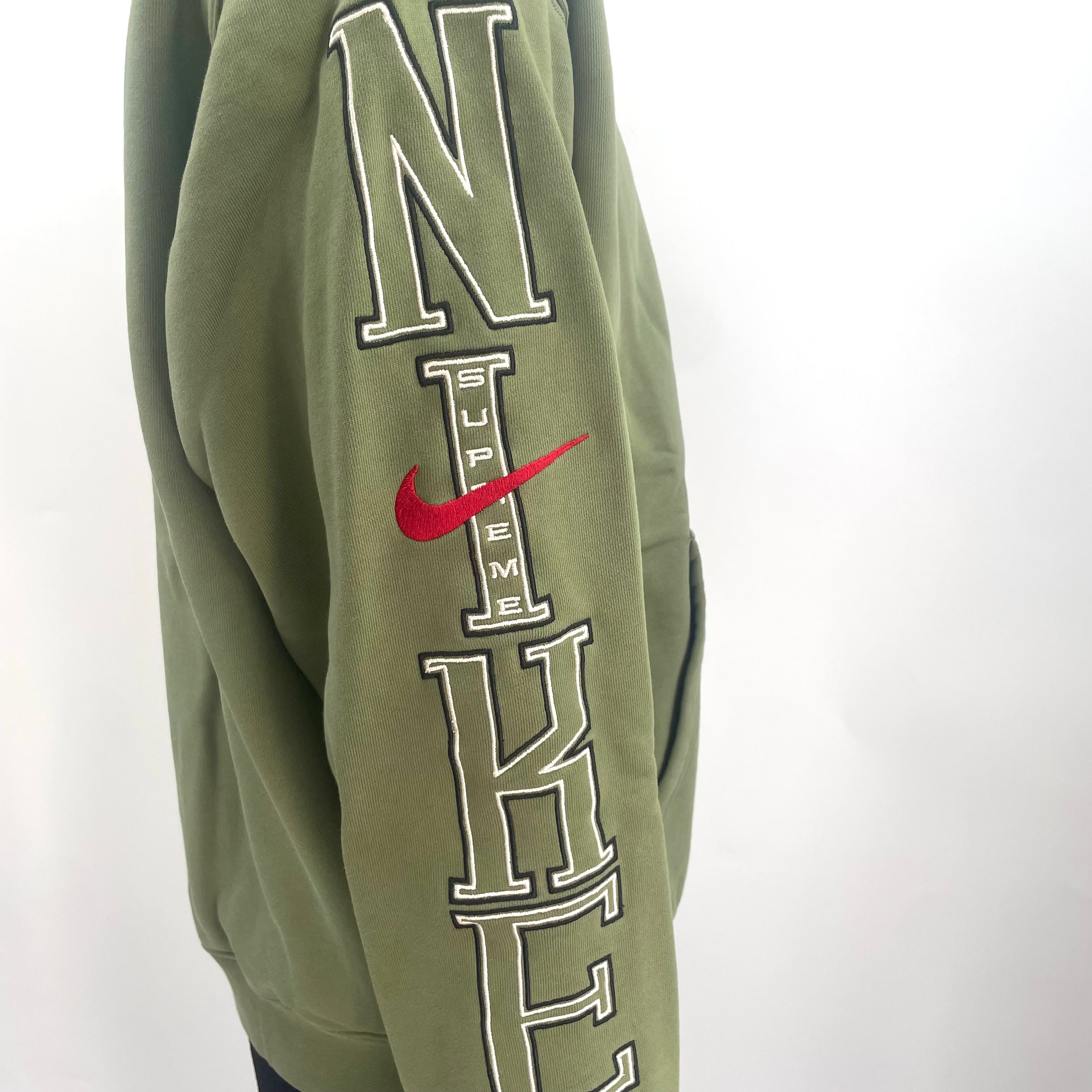 The Jordan x Supreme Collaboration Hoodie Khaki Green is a premium streetwear hoodie that combines Jordan Brand’s athletic