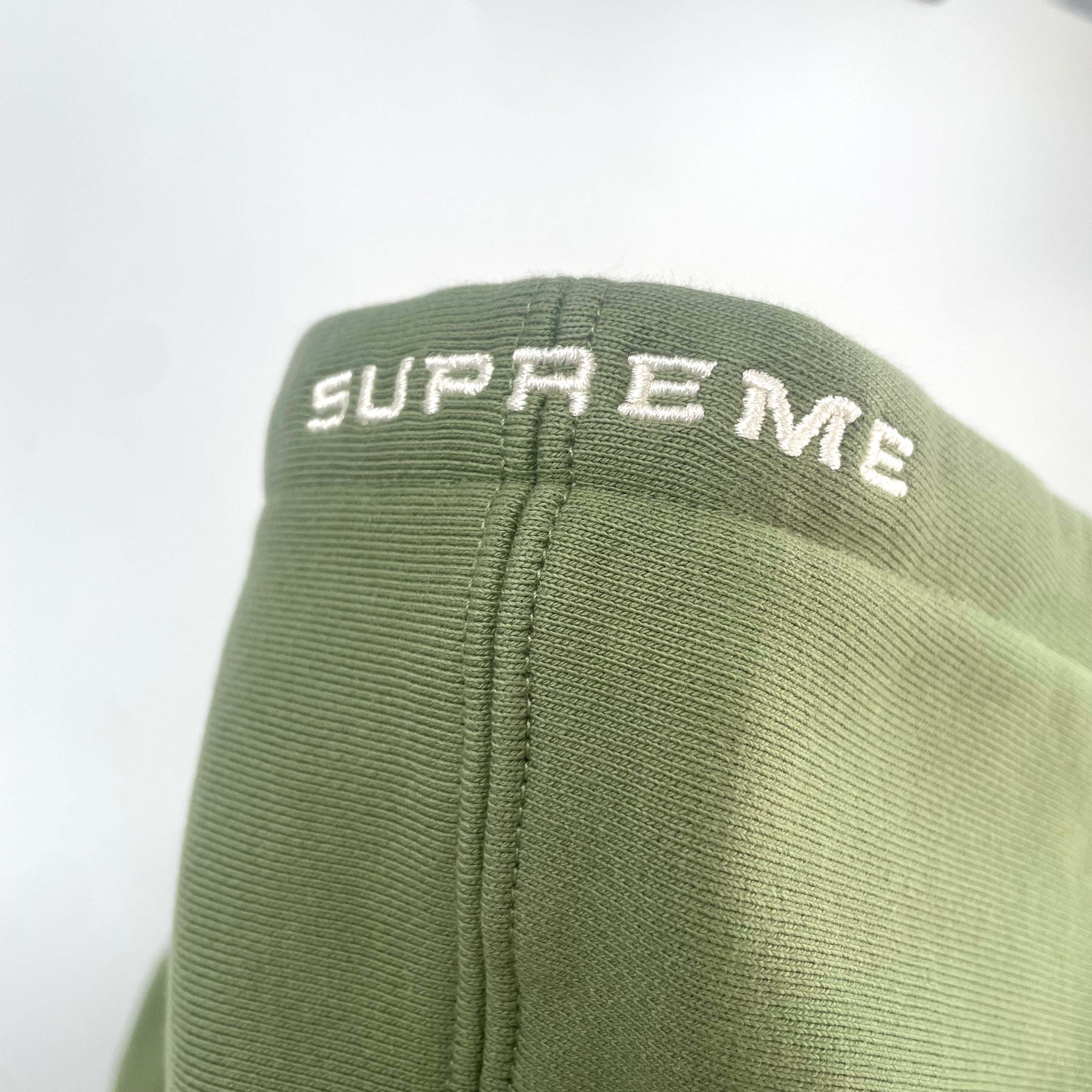 The Jordan x Supreme Collaboration Hoodie Khaki Green is a premium streetwear hoodie that combines Jordan Brand’s athletic