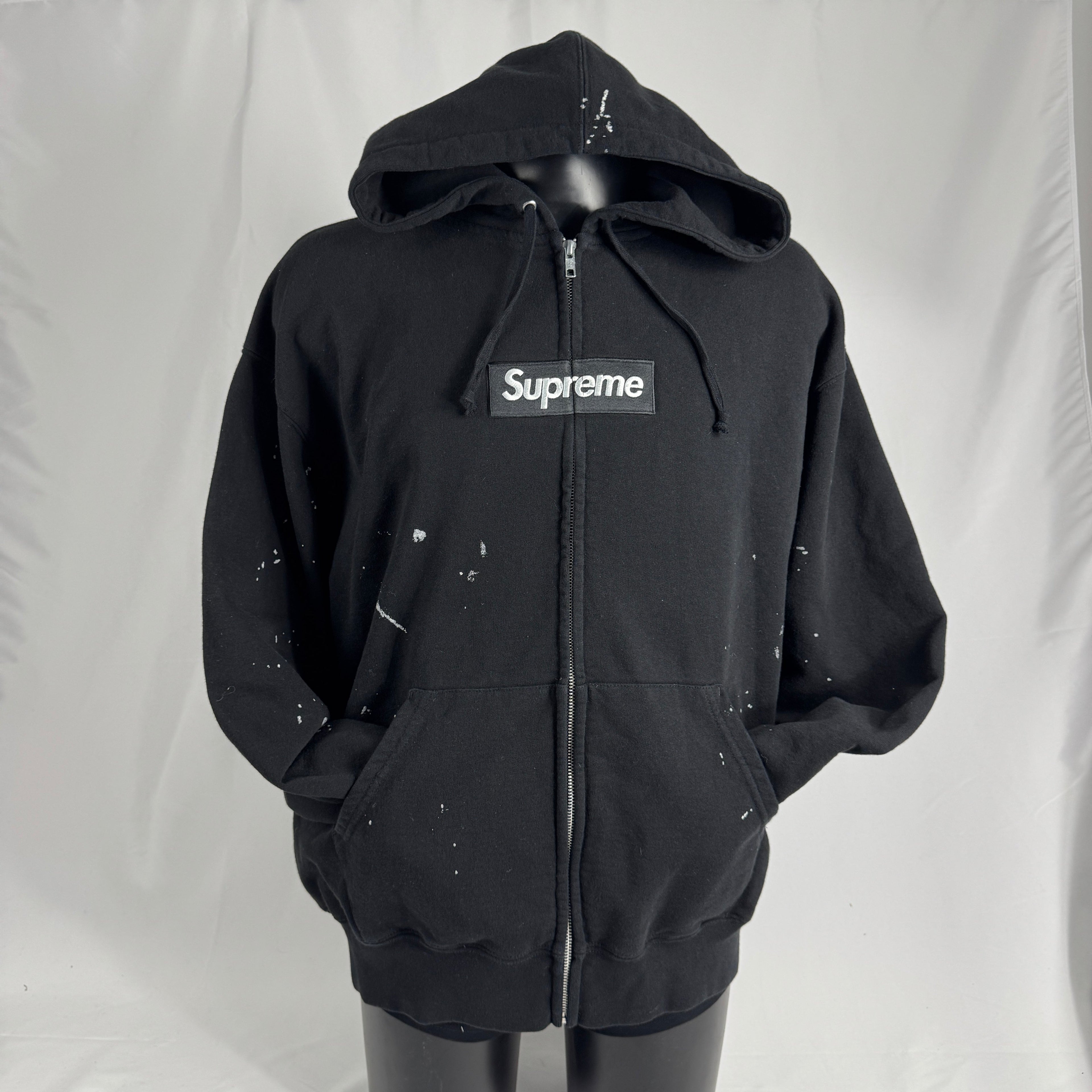 The Supreme x Maison Margiela Box Logo Zip Up is a limited-edition collaboration hoodie featuring Supreme’s iconic Box Logo,