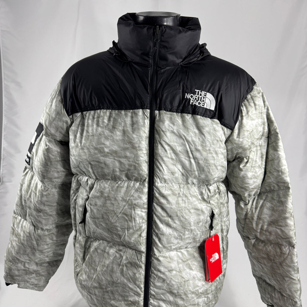 The Supreme x The North Face Nuptse is a collaborative version of The North Face’s iconic down jacket, combining the classic