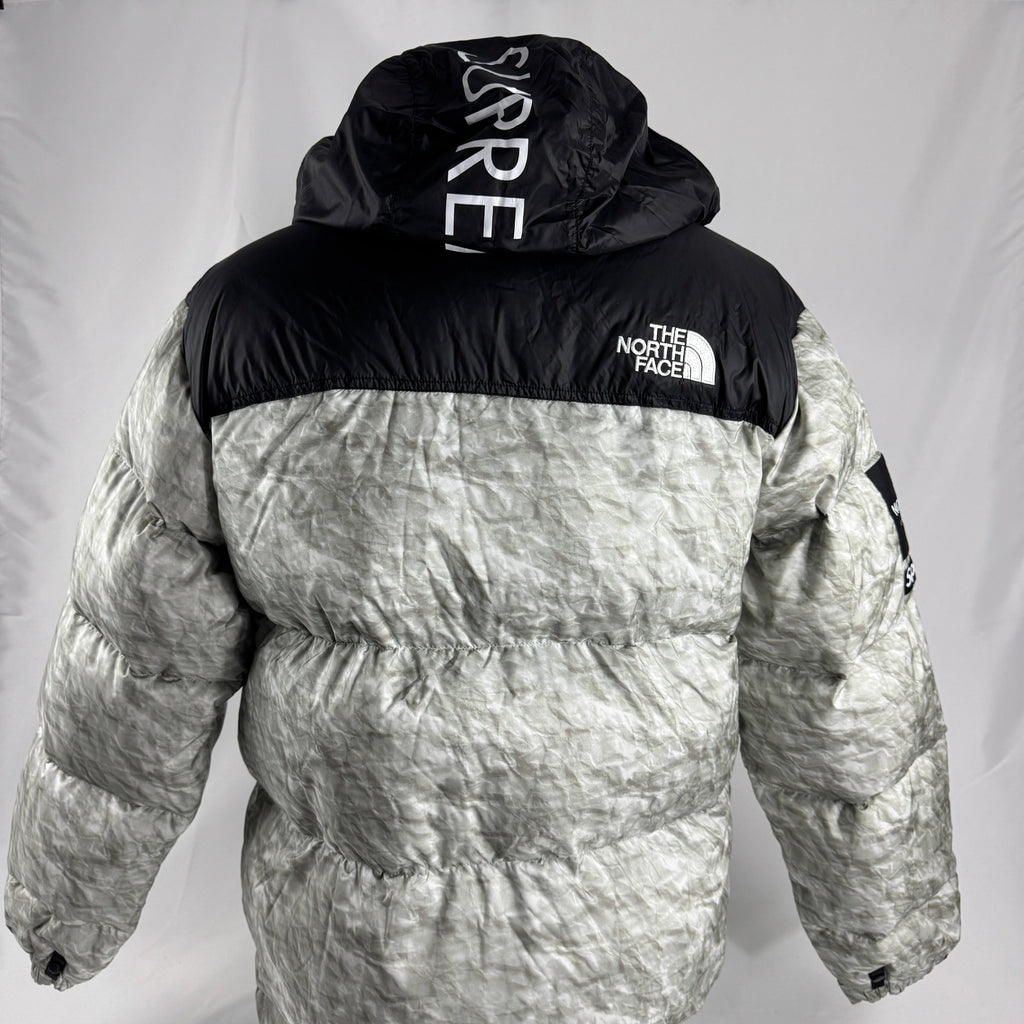 The Supreme x The North Face Nuptse is a collaborative version of The North Face’s iconic down jacket, combining the classic