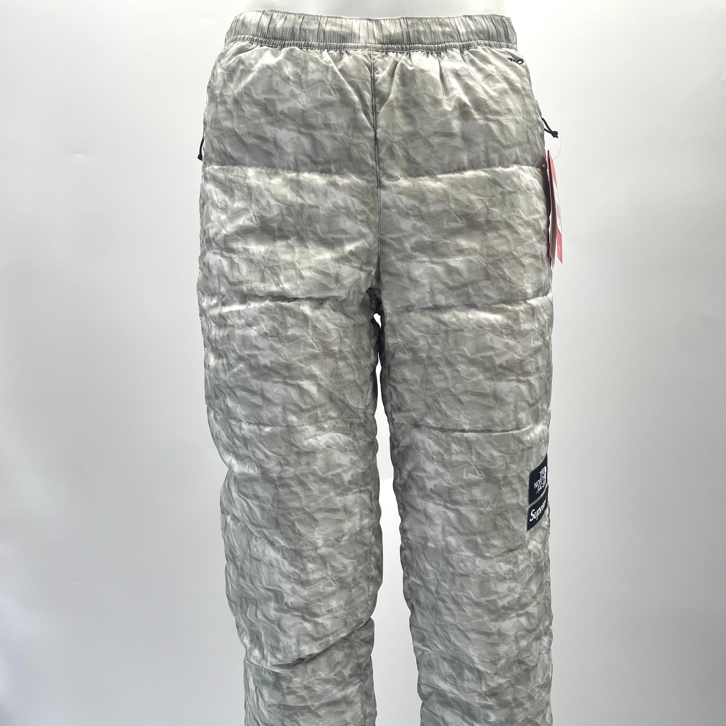 A standout Supreme x The North Face Nuptse pant in the distinctive paper-print design, finished with insulated padding and