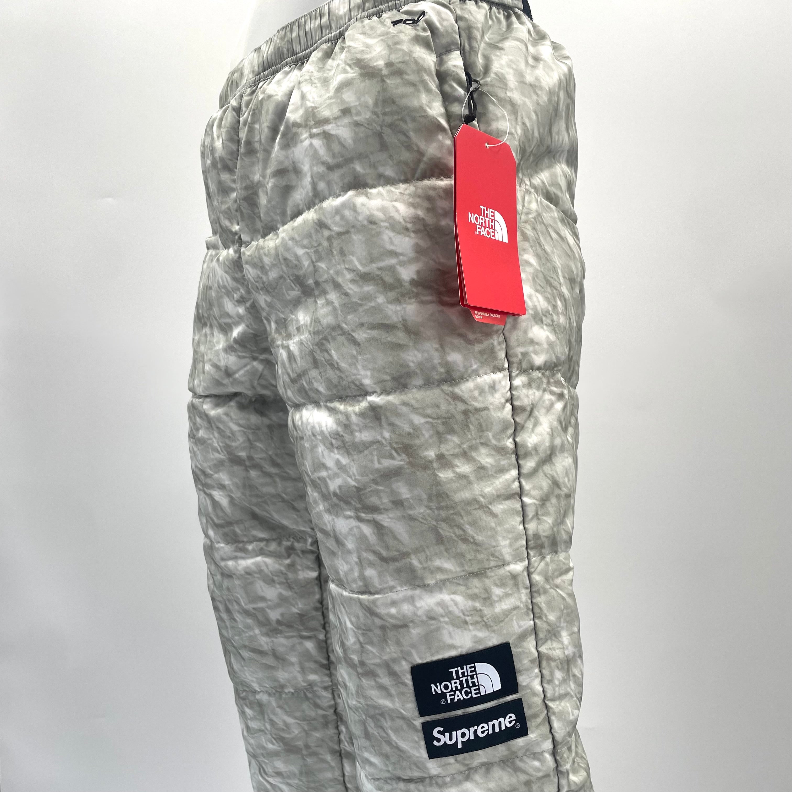 A standout Supreme x The North Face Nuptse pant in the distinctive paper-print design, finished with insulated padding and