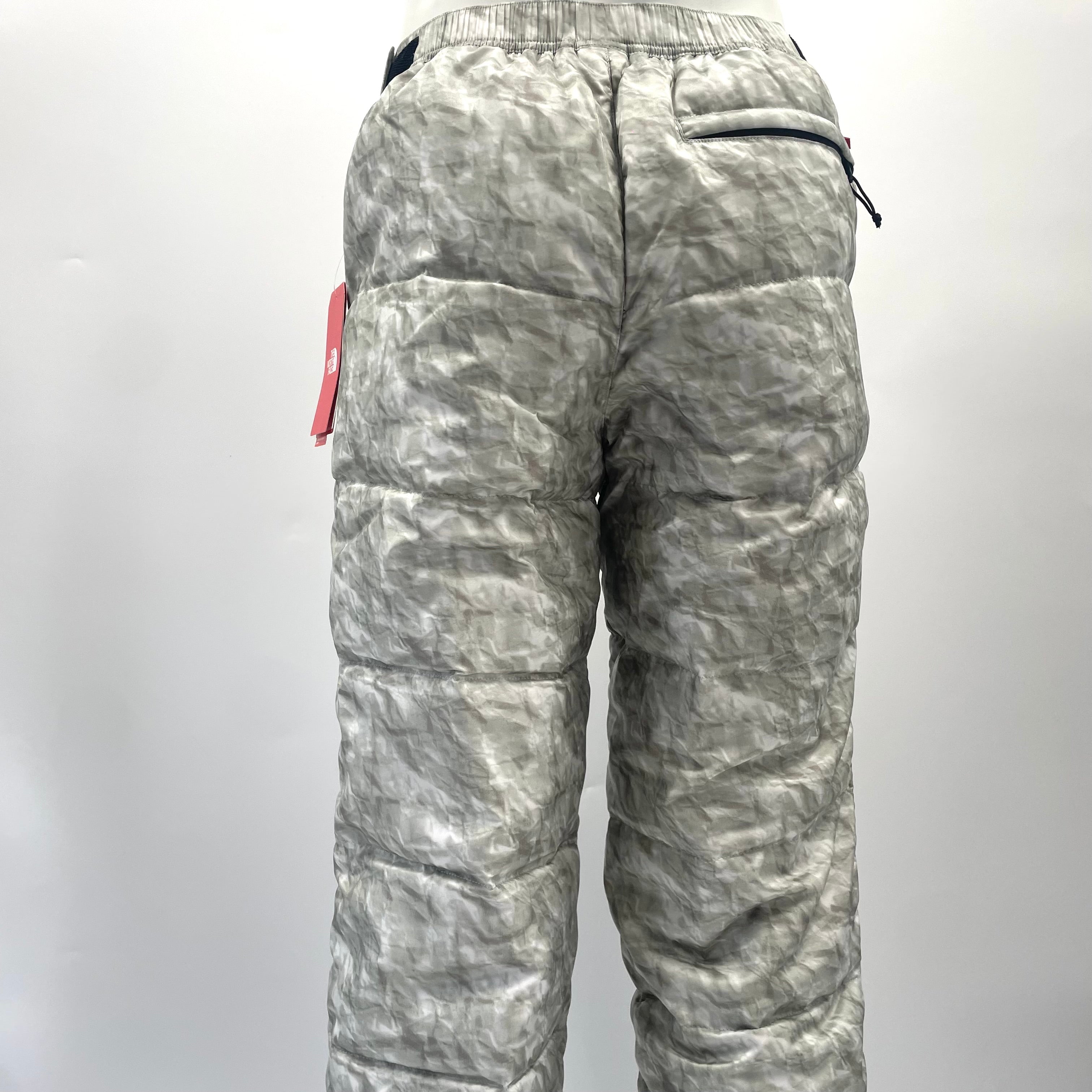 A standout Supreme x The North Face Nuptse pant in the distinctive paper-print design, finished with insulated padding and