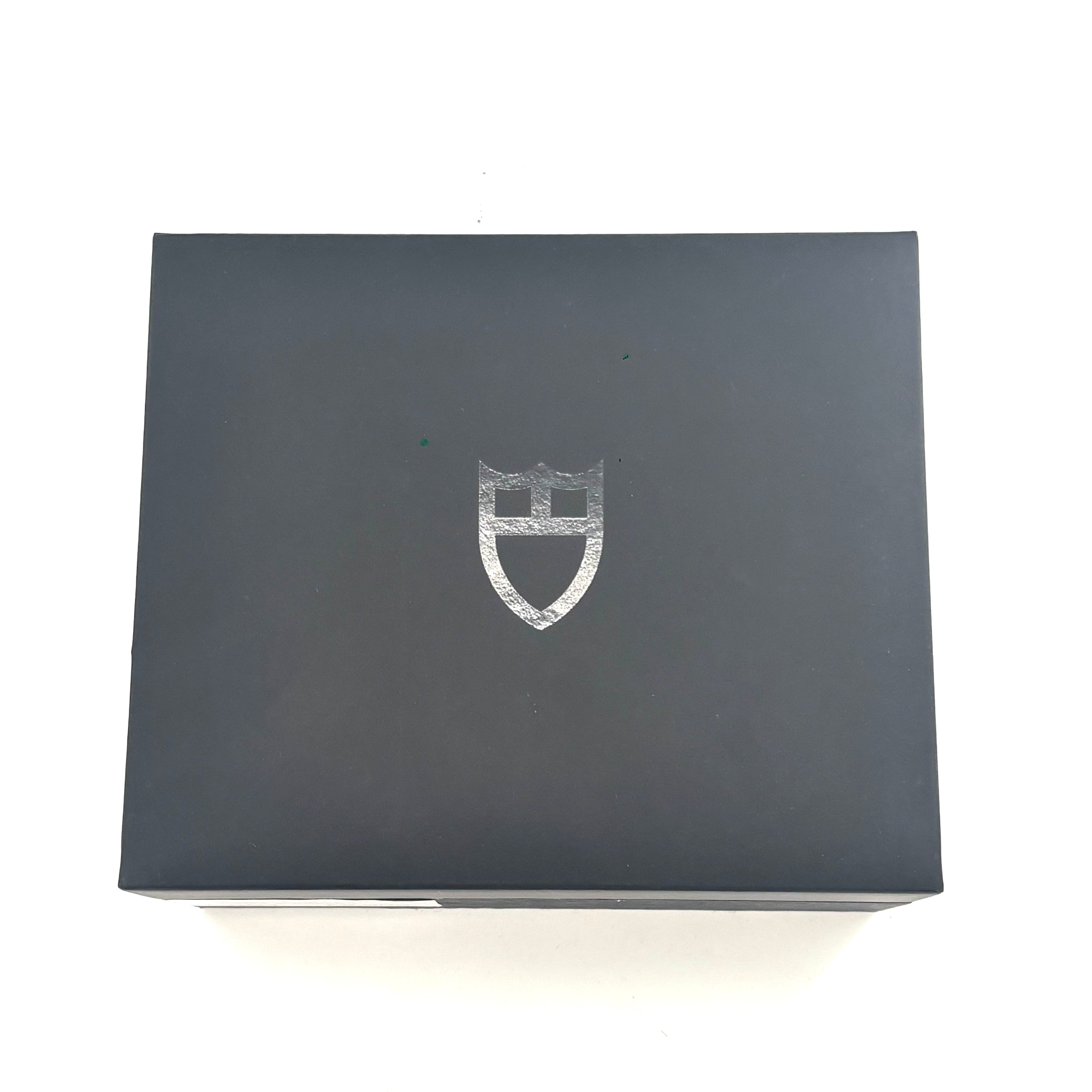 Black rectangular box with a silver shield logo on the lid, displayed on a white background.