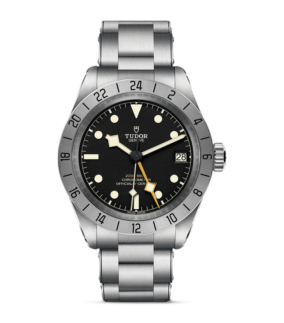 TUDOR Black Bay Pro stainless steel watch with black dial, silver bezel, vintage cream markers, date display and metal bracelet.
