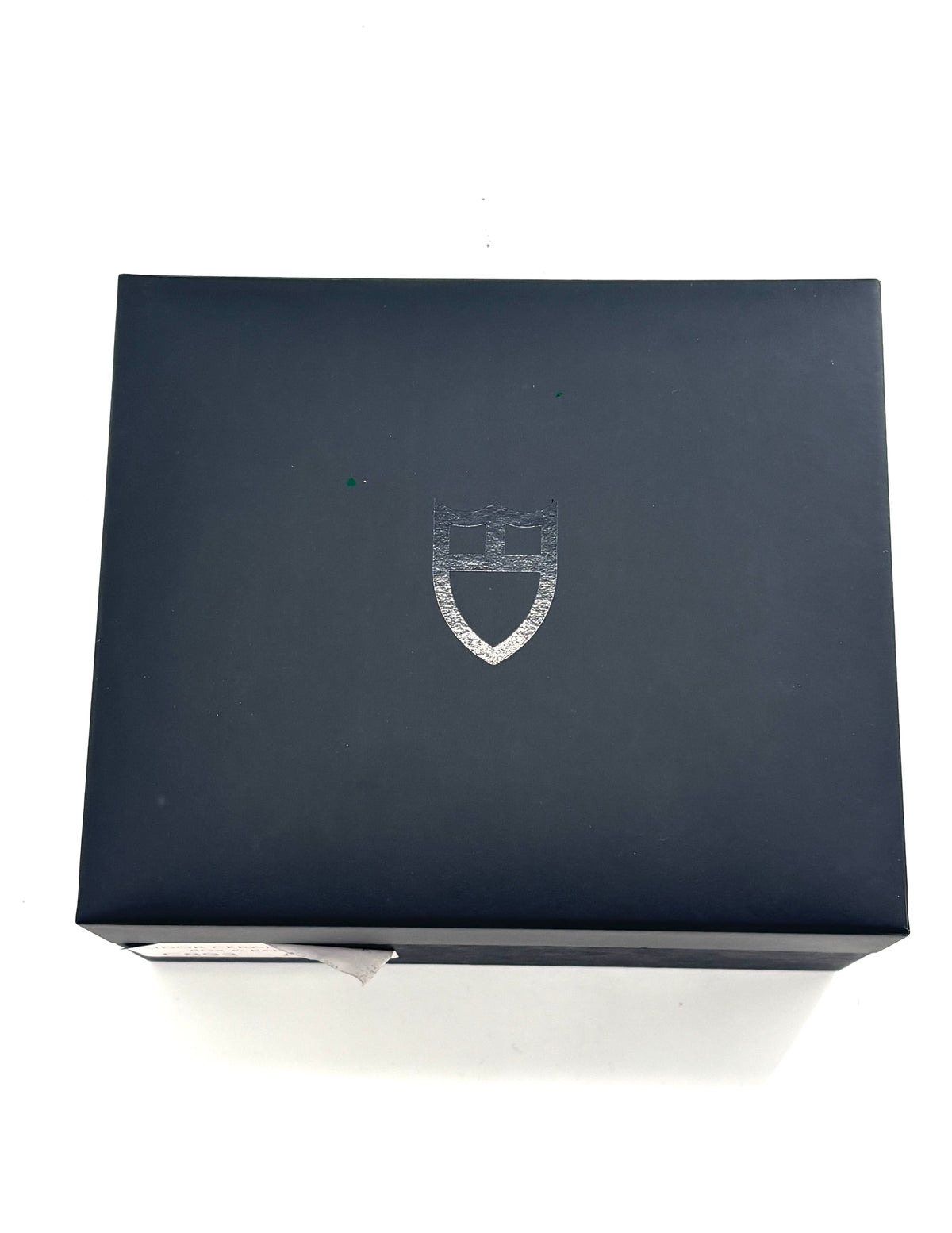 TUDOR black rectangular box with a silver shield logo on the lid, shown from above on a white background.